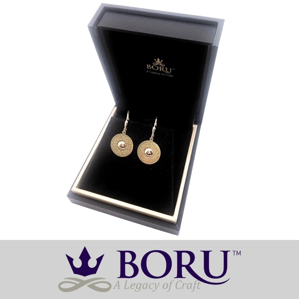 Gold earrings in a Boru box on a white background