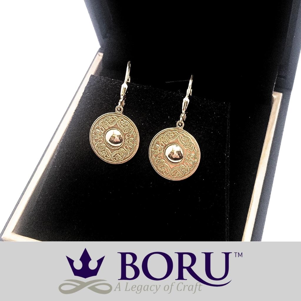 Gold earrings on a black stand with Boru logo at the bottom.
