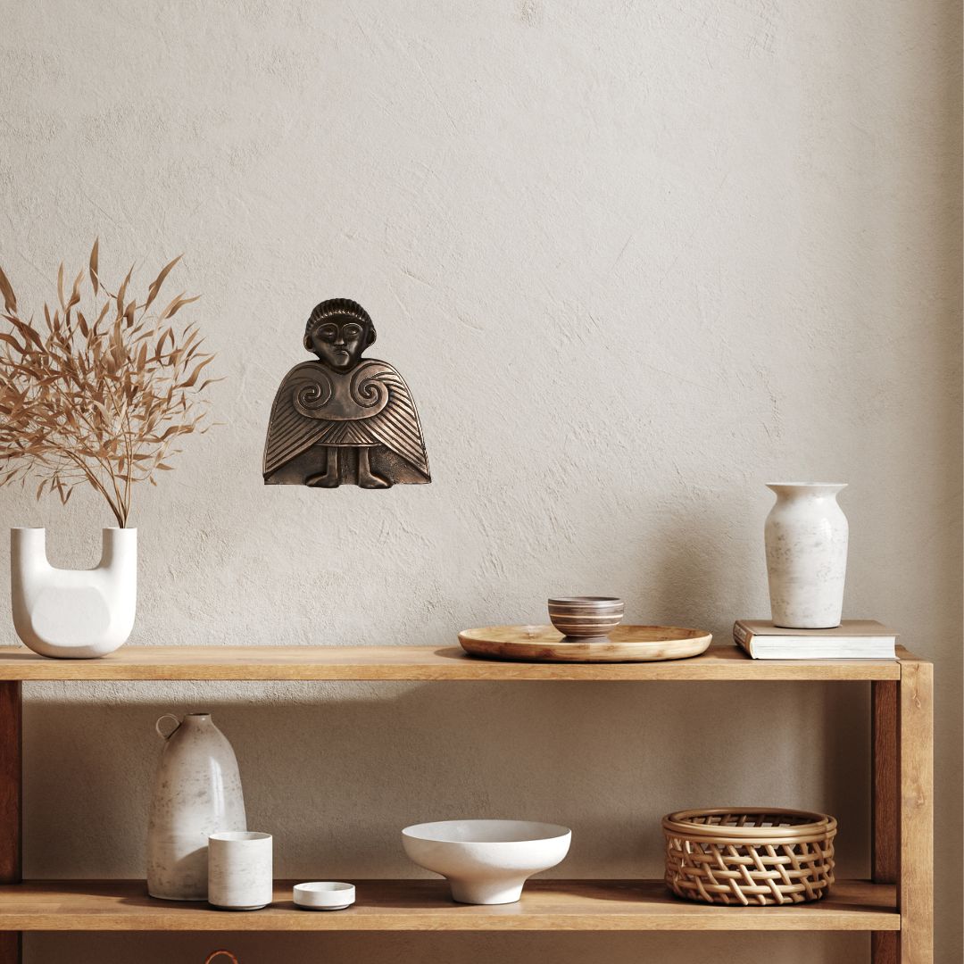 Wooden shelf with decorative items including a statue, vases, and bowls against a plain wall.
