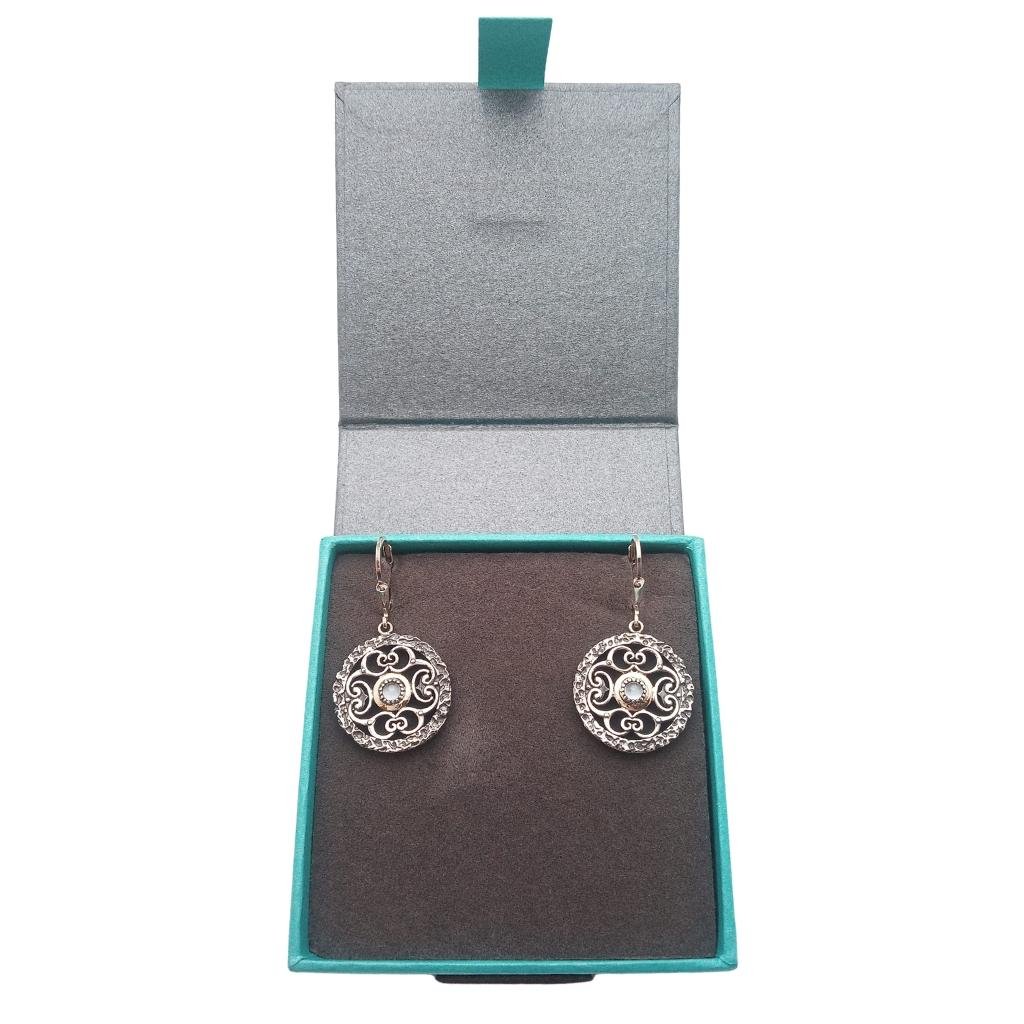 Sterling Silver and 10k Gold Whirlpool Earrings with Sky Blue Topaz
