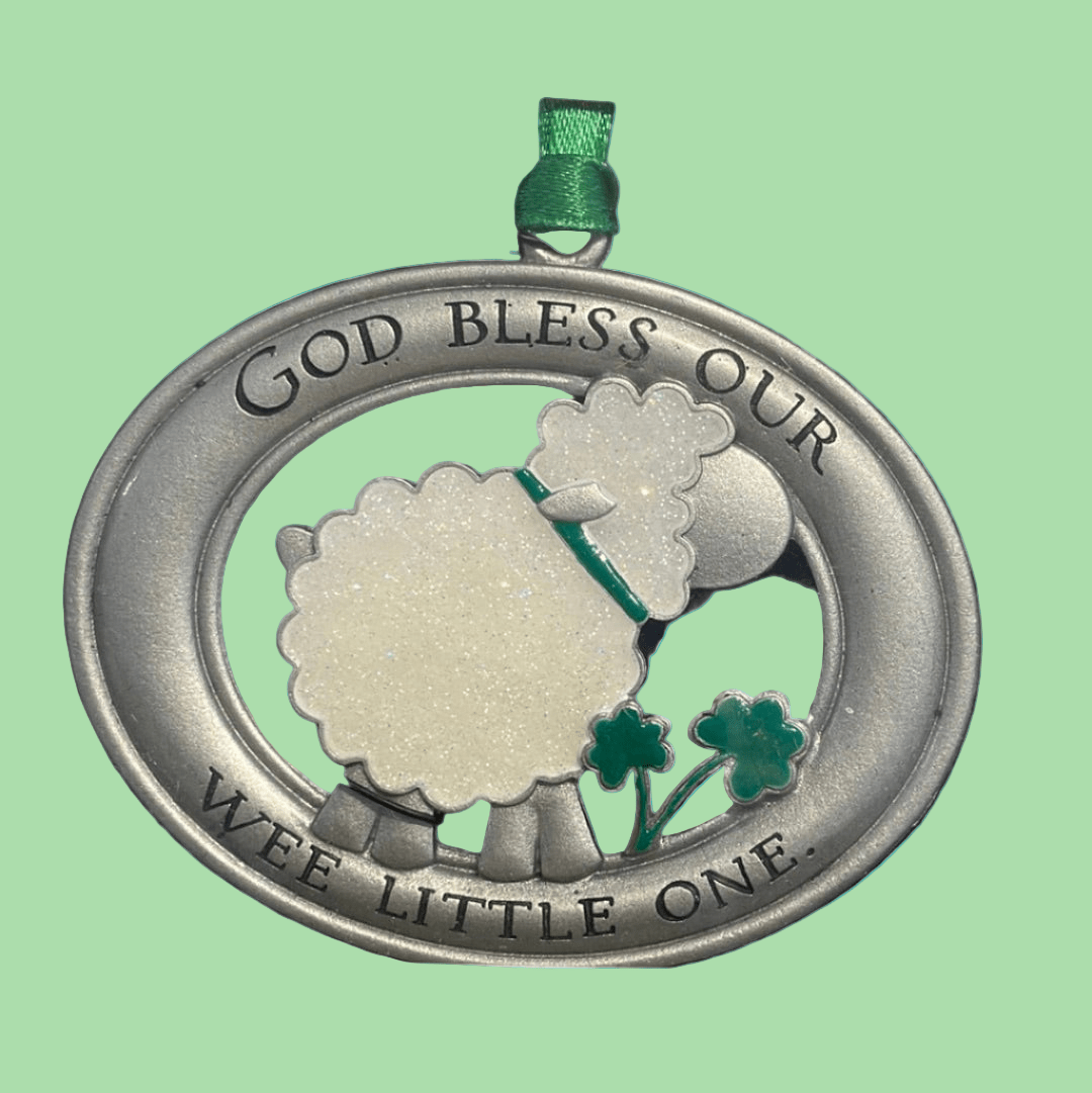 Metallic pendant with sheep design and text on a blue background